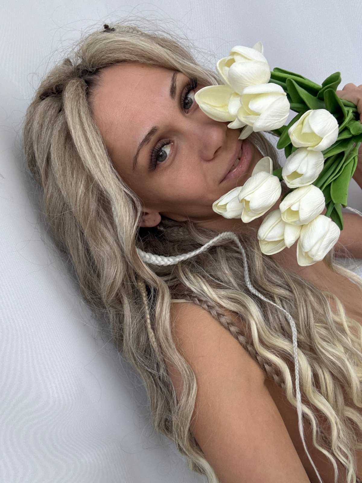 Woman photographed with white tulips in Rusanovo, Russia
