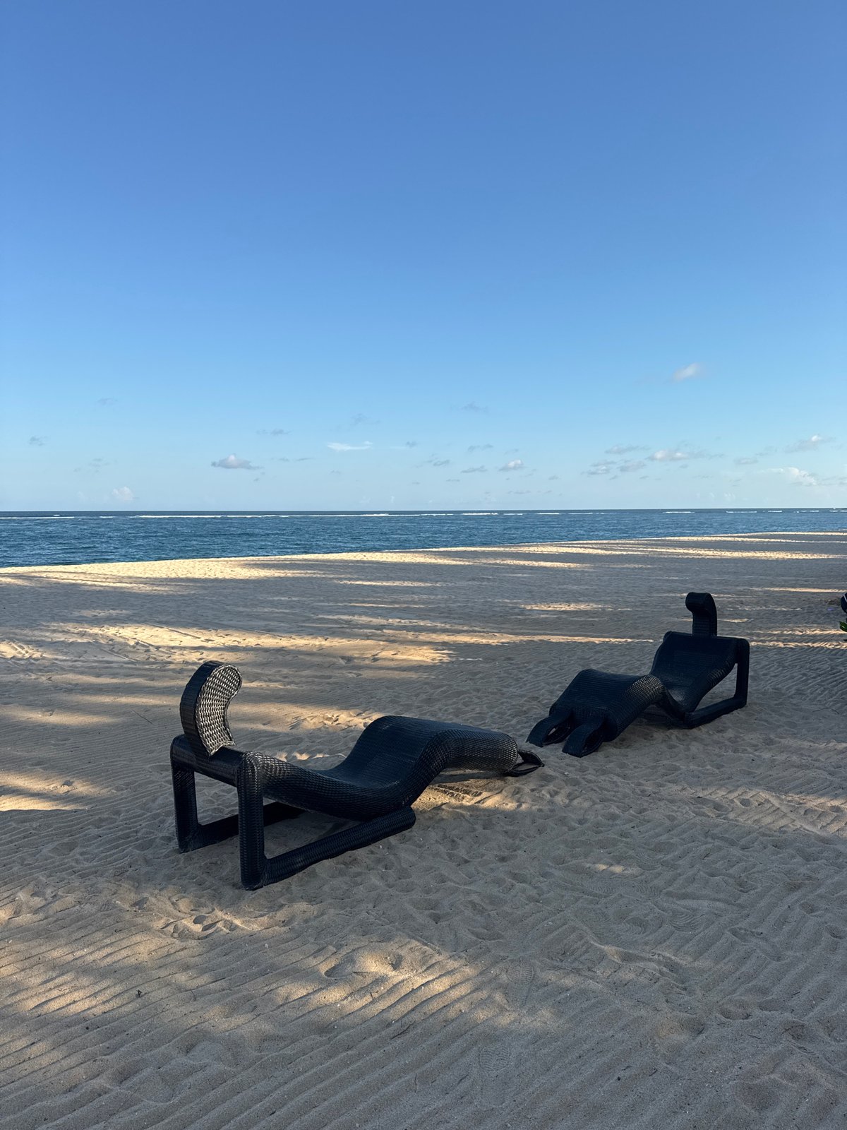Beach chairs and palm trees documented at Indonesian resort