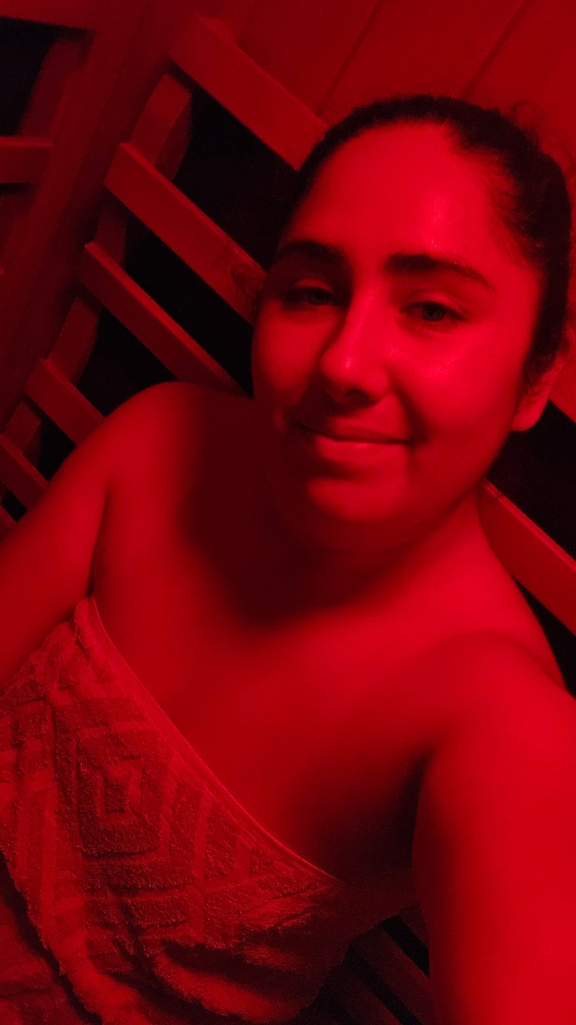 Woman uses red-light sauna therapy in Puebla, Mexico