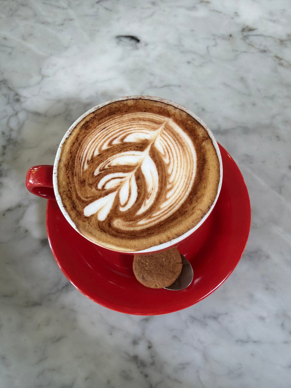 Cappuccino with latte art served in North Kuta