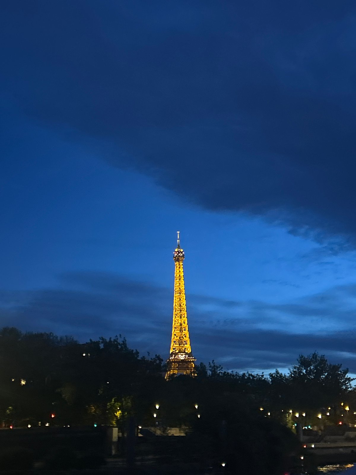 Eiffel Tower illuminated at evening twilight in Paris