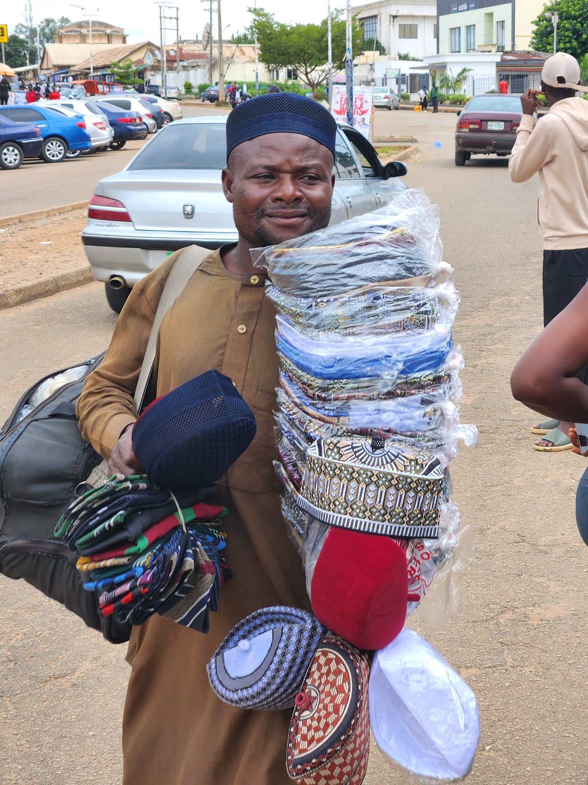 Midday street life and outdoor prayers in Jos, Nigeria