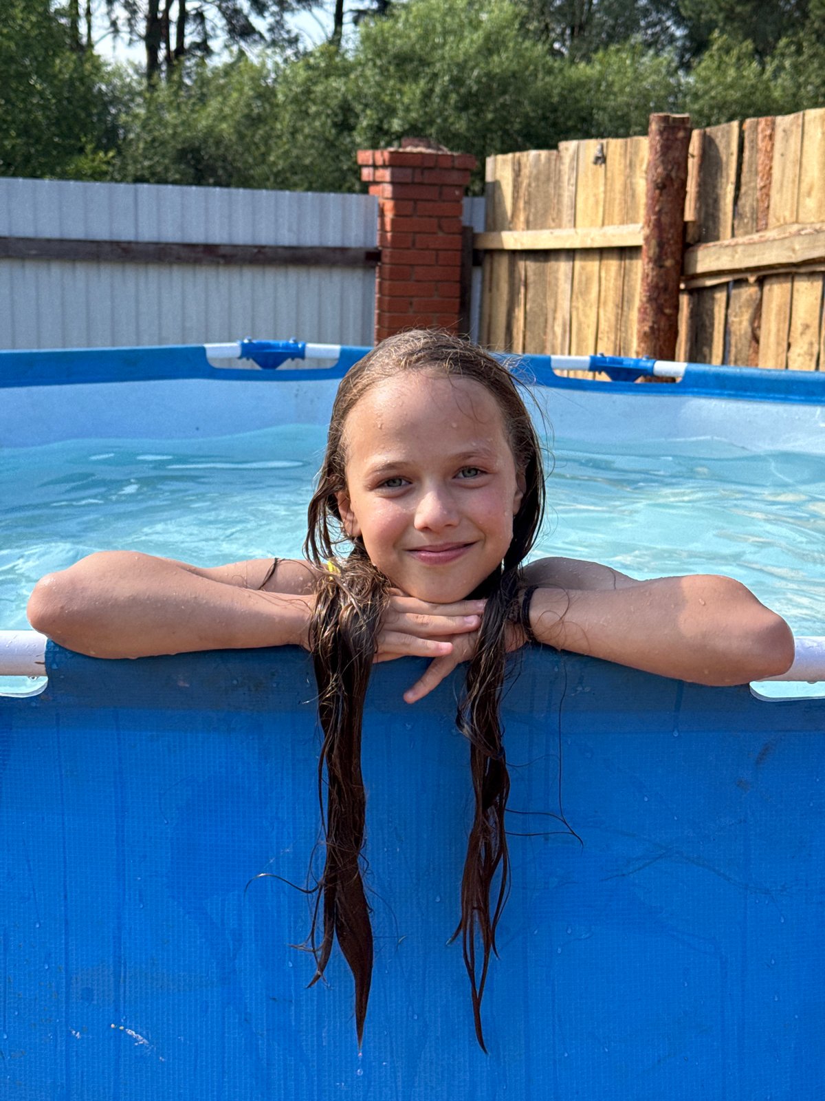 Backyard pool day with kids splashing around in the sun