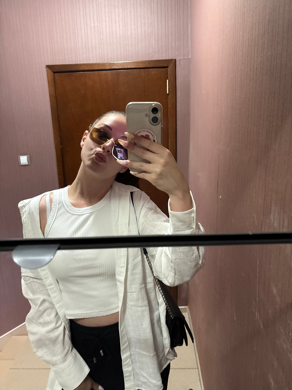 Woman takes mirror selfies in bedroom in Bulgarovo, Bulgaria