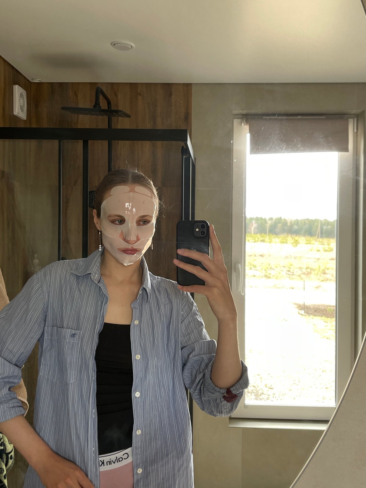 Woman documents skincare routine with face mask in Russian village