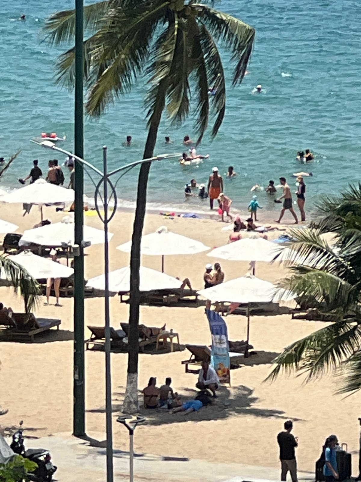 Nha Trang beachfront: busy shoreline, coastal streets, and a quirky scooter