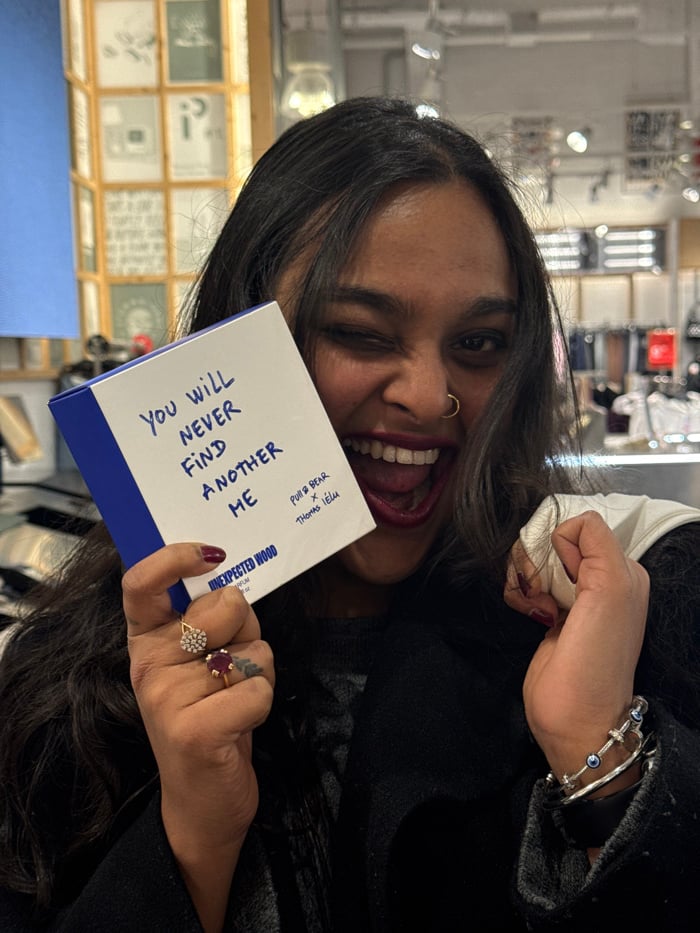 Woman displays Pull & Bear collaboration box in Portugal
