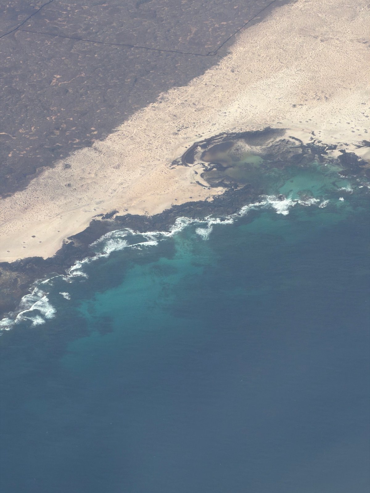 Coastal landscape captured showing terrain-to-beach transition in Los Lagos