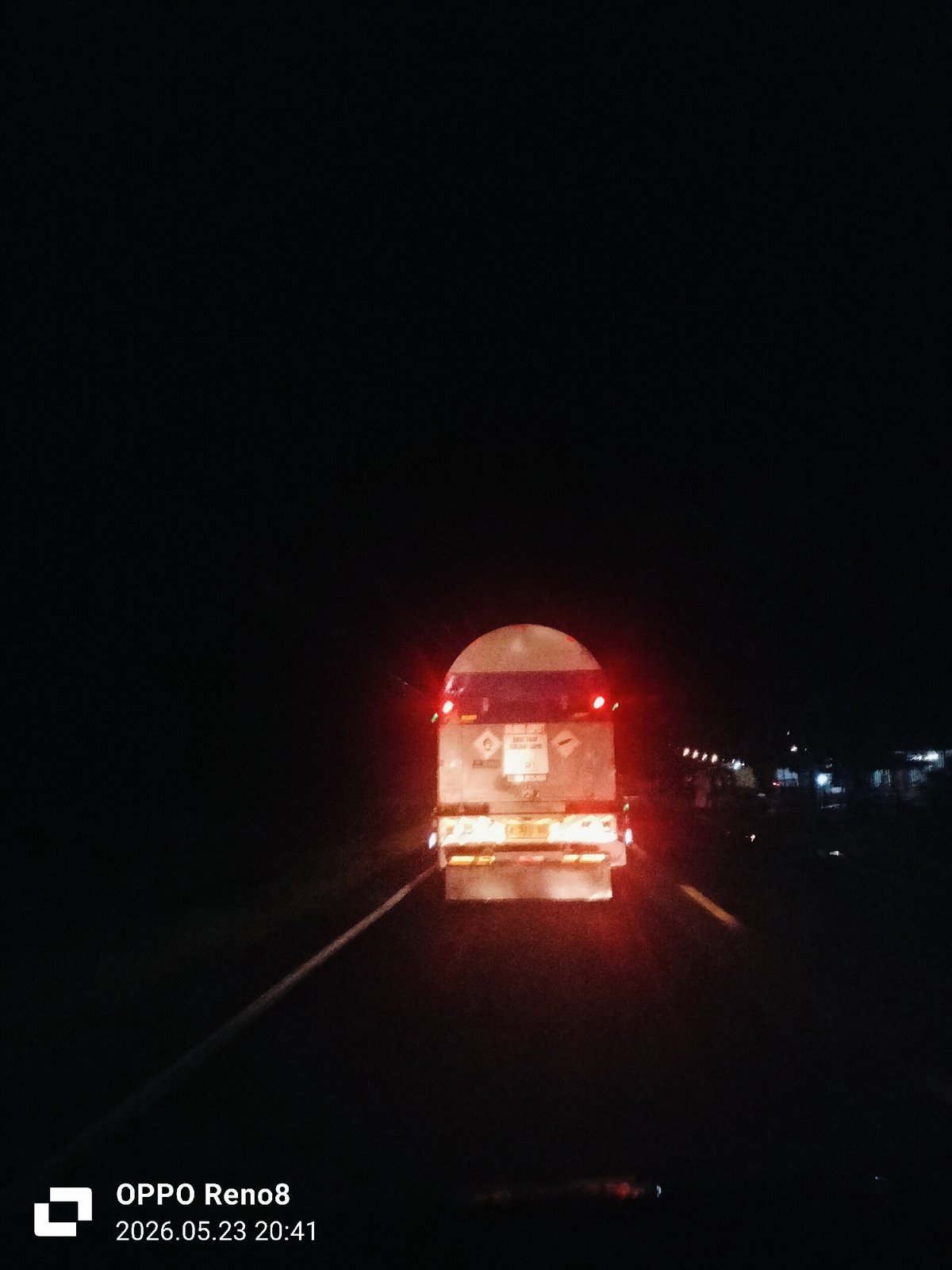 Tanker truck travels nighttime road in Pandrahkandeh, Indonesia