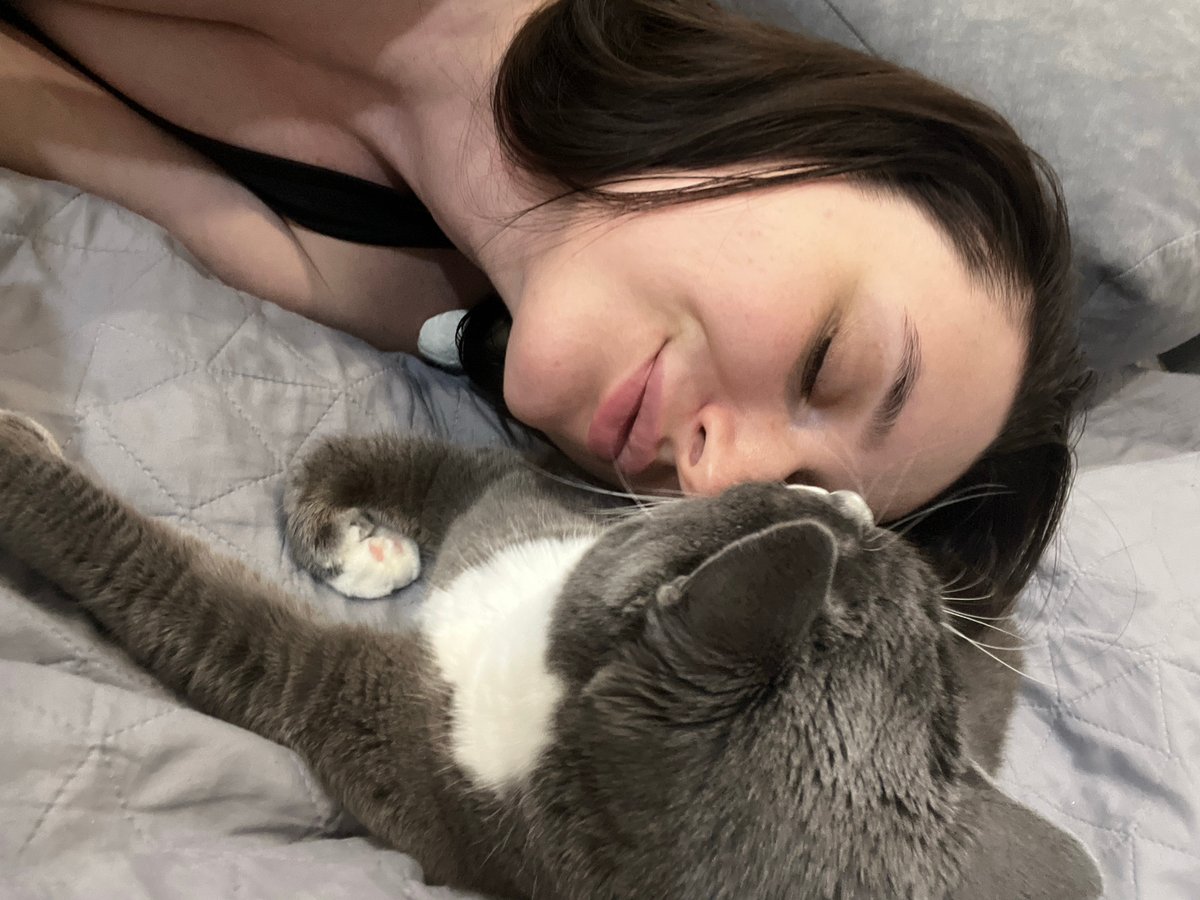Woman and tuxedo cat share quiet domestic moments in Tyumen