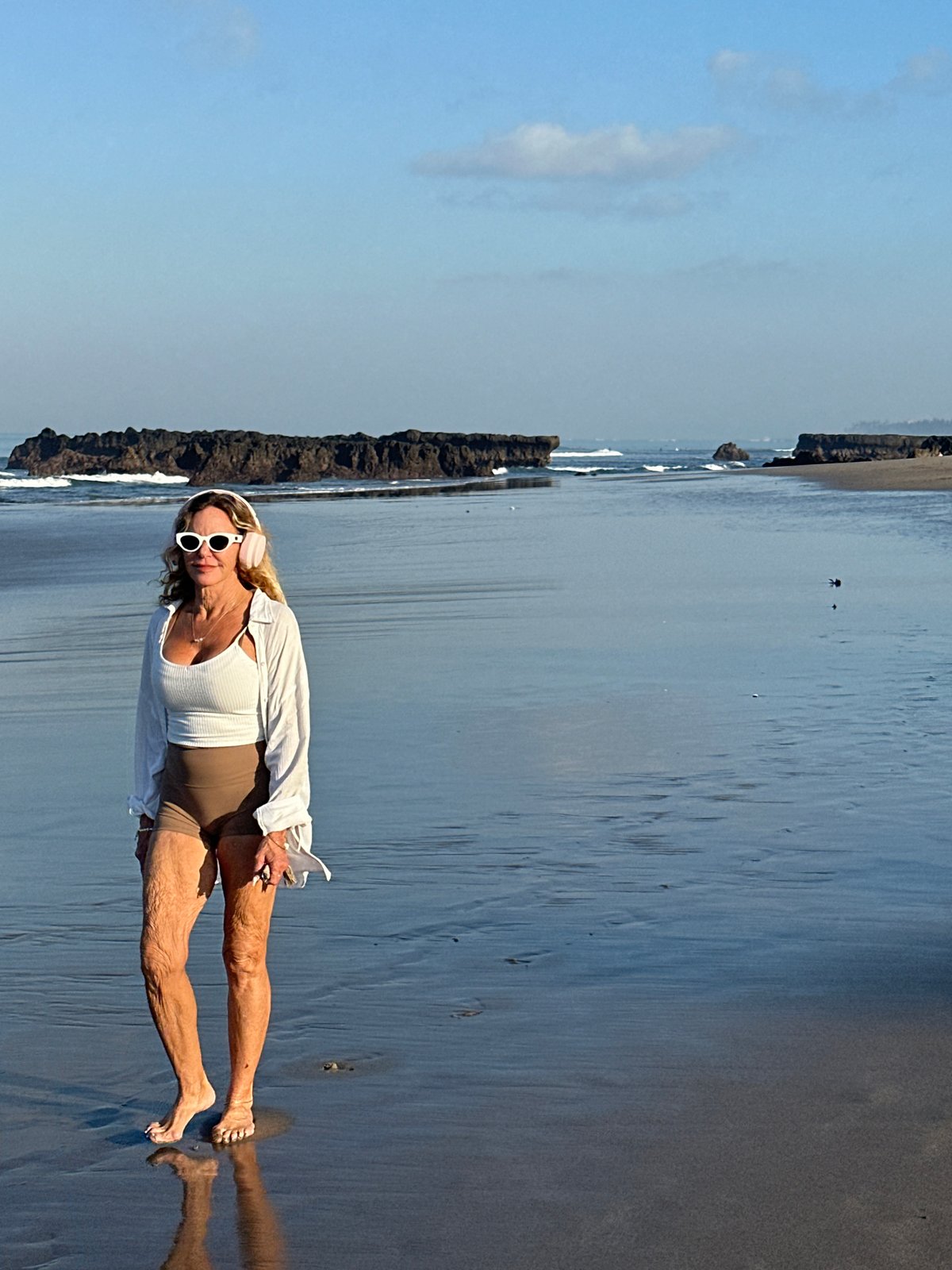 Surfers, joggers, and beachgoers on North Kuta at low tide