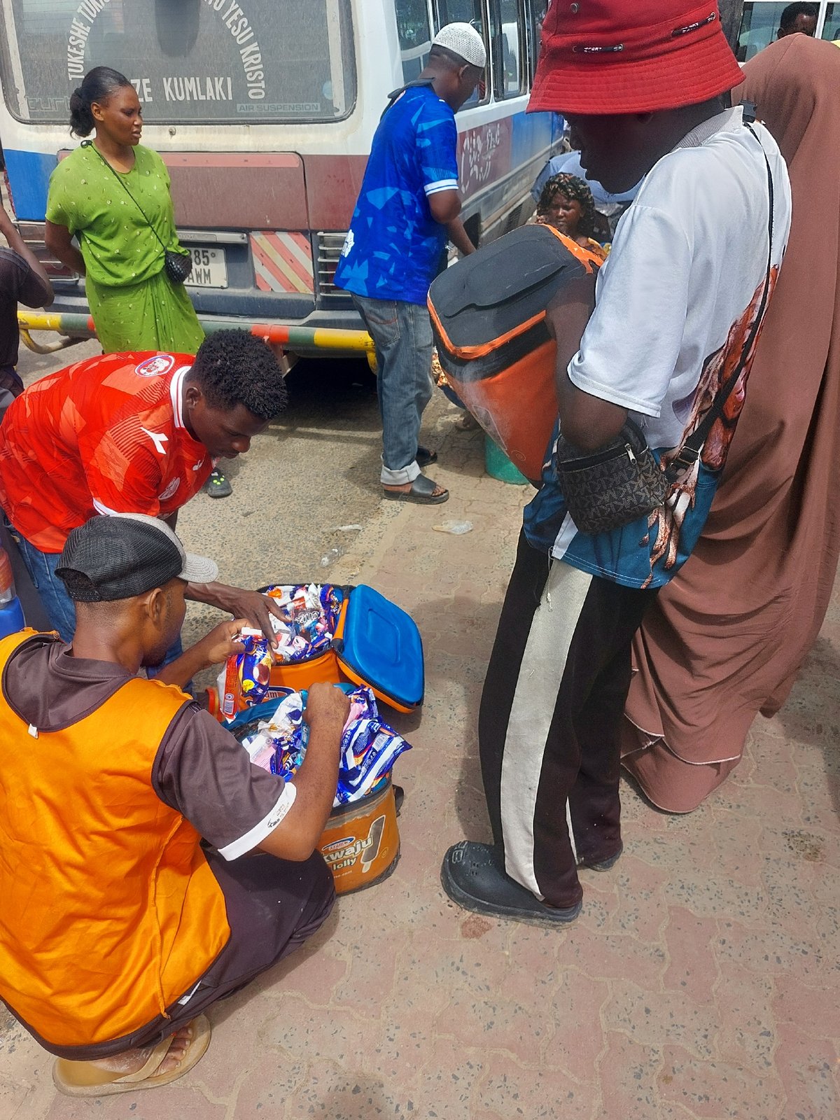 Street vendors serve customers at busy Dar es-Salaam transport hub