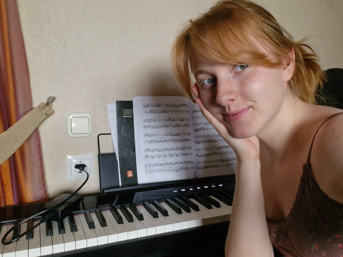 Woman with red hair and white cat photographed indoors