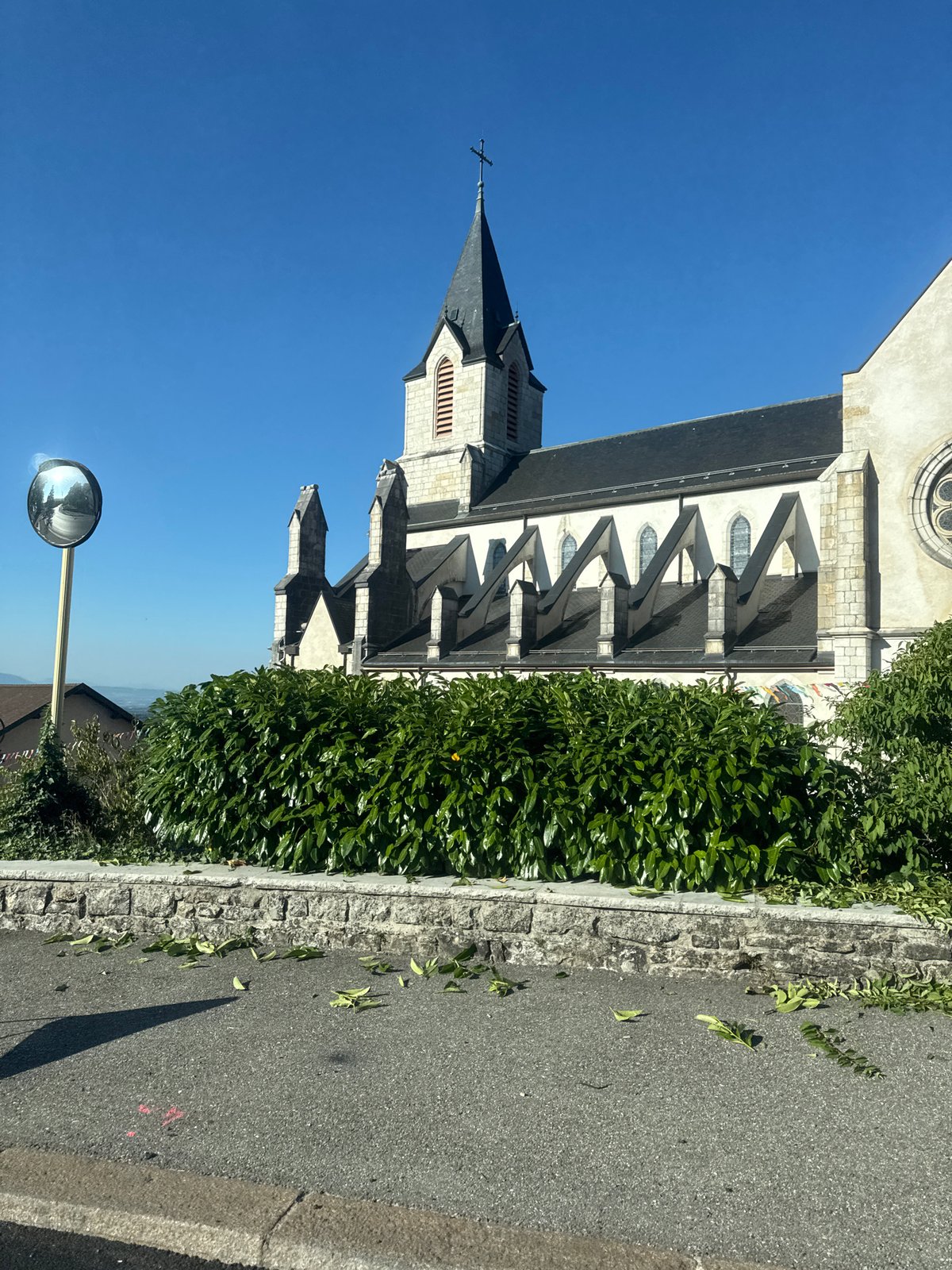 Church steeple and festive banners in central Gex, France