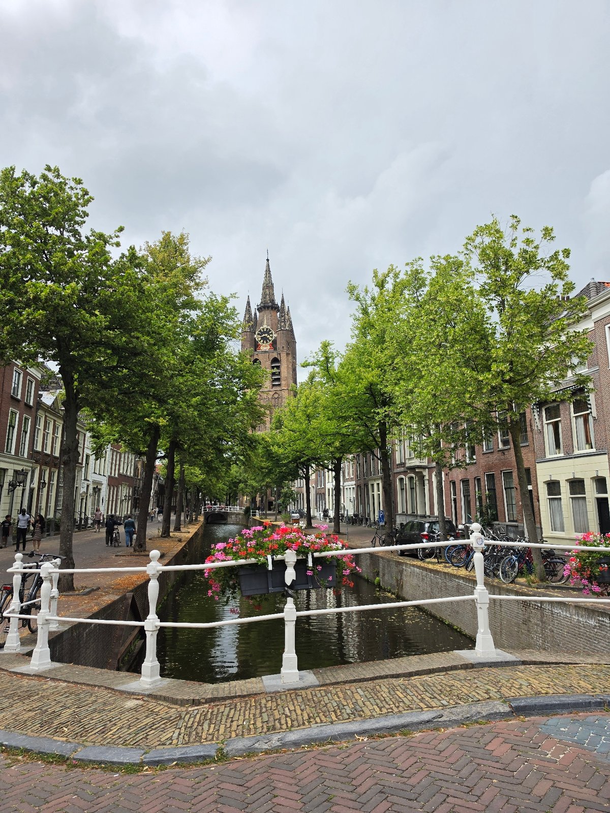 Canals, flowers, and historic stonework in central Delft
