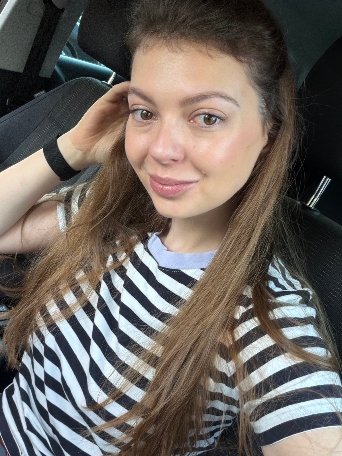 Woman exits car on sunny Moscow morning