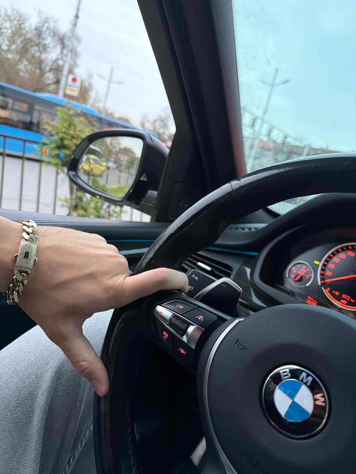 Young man documents selfie session and car details indoors