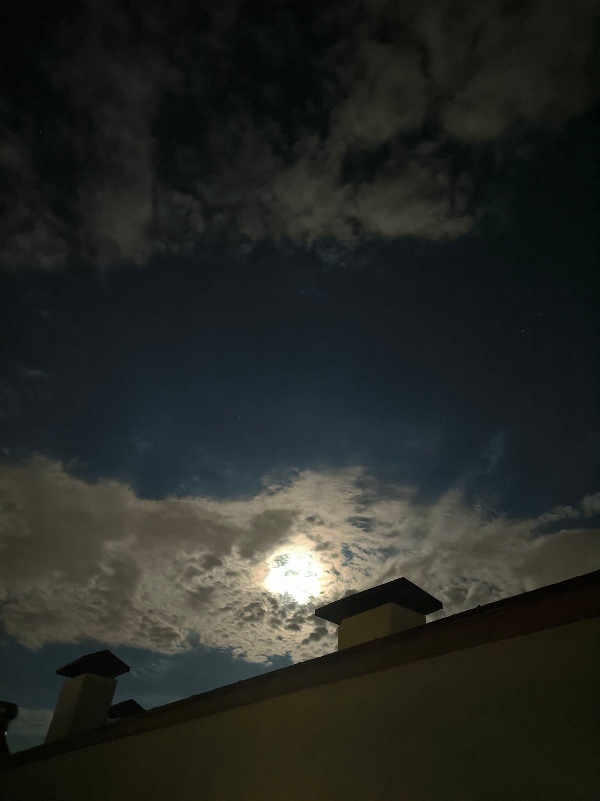 Moonlit clouds drift over Chișinău rooftops on a July night
