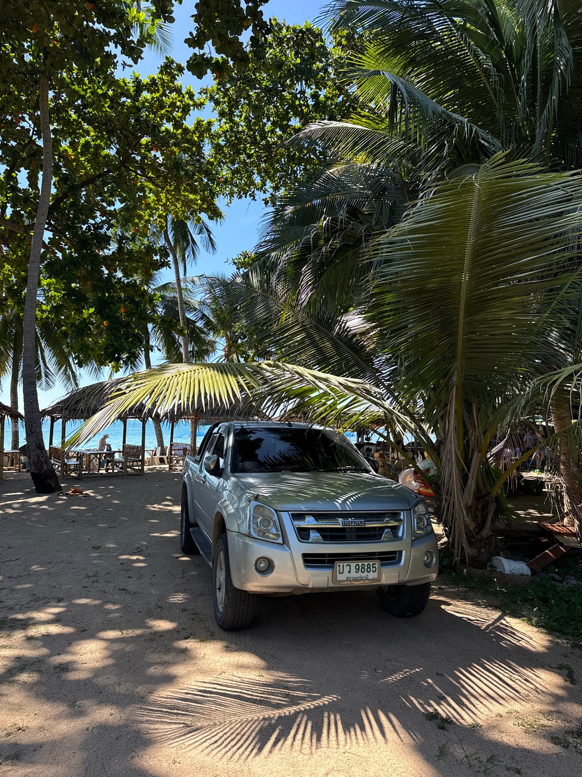 Vehicles parked beachside on Ko Samui, Thailand