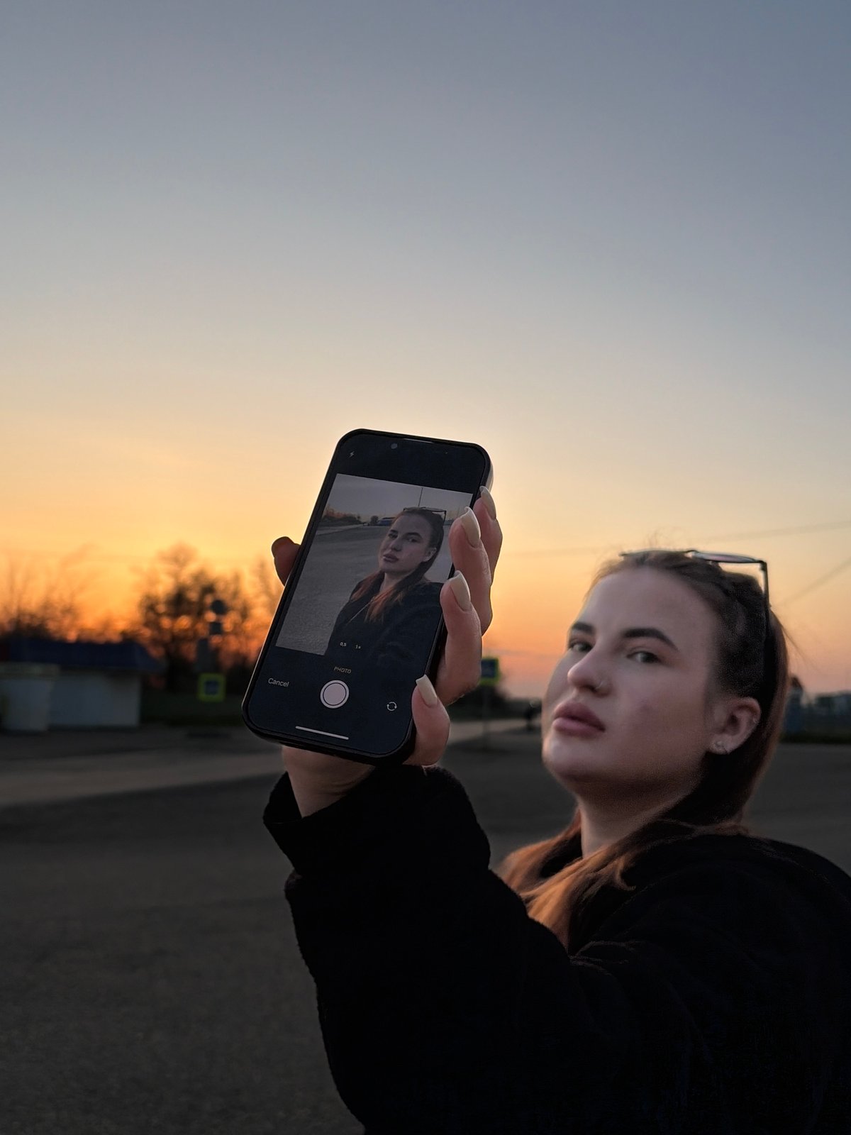 Woman takes selfies outdoors in Novopokrovskaya, Russia