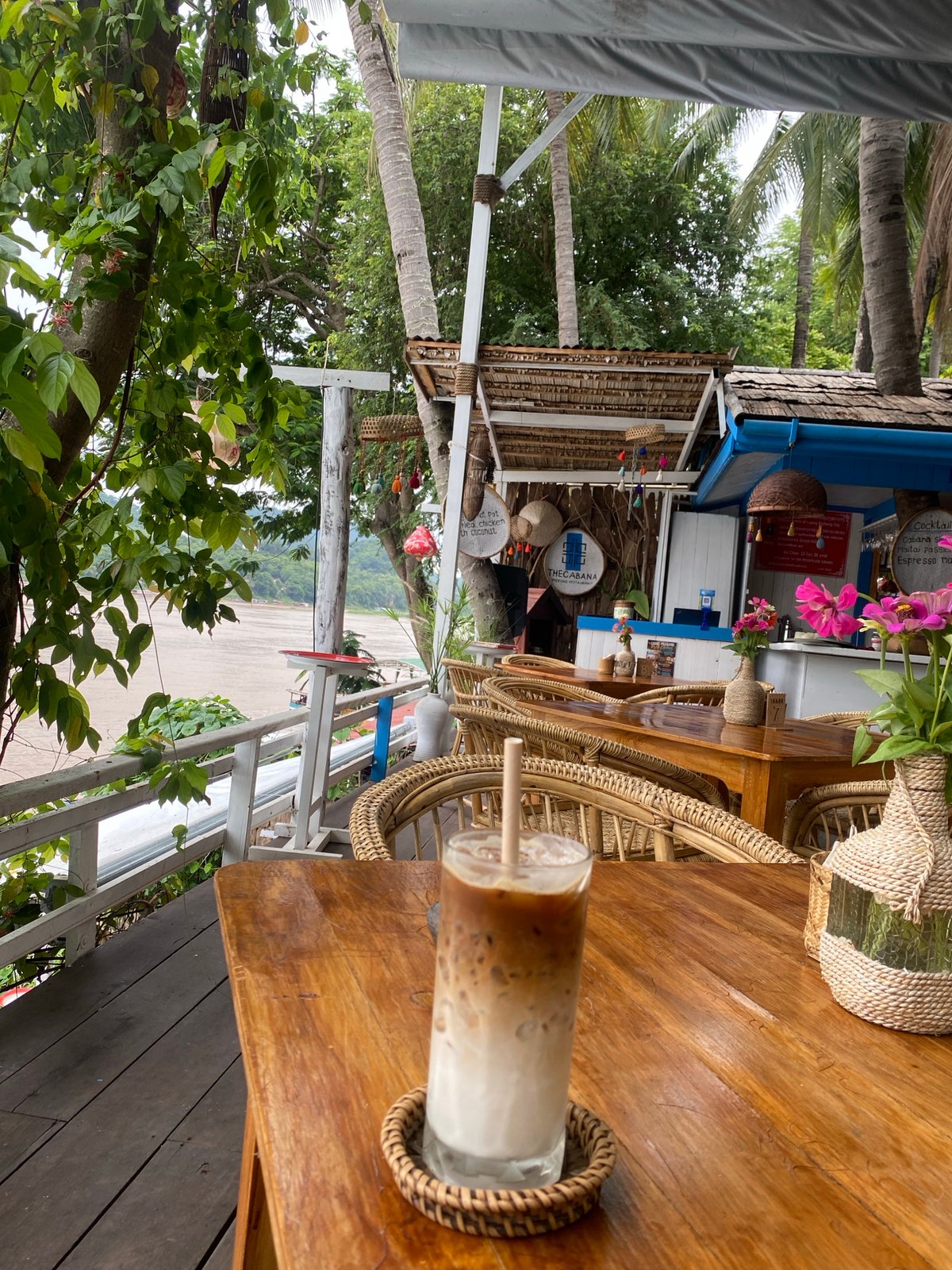 Iced coffee and Mekong River views at a Luang Prabang cafe