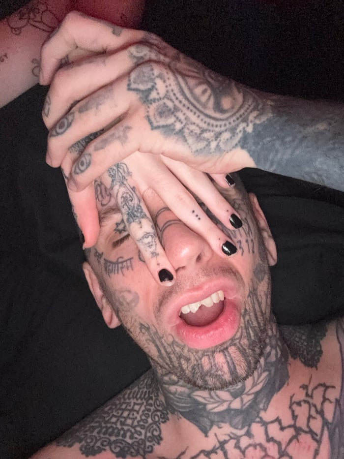 Tattooed individual spotted wearing hockey mask in Buenos Aires
