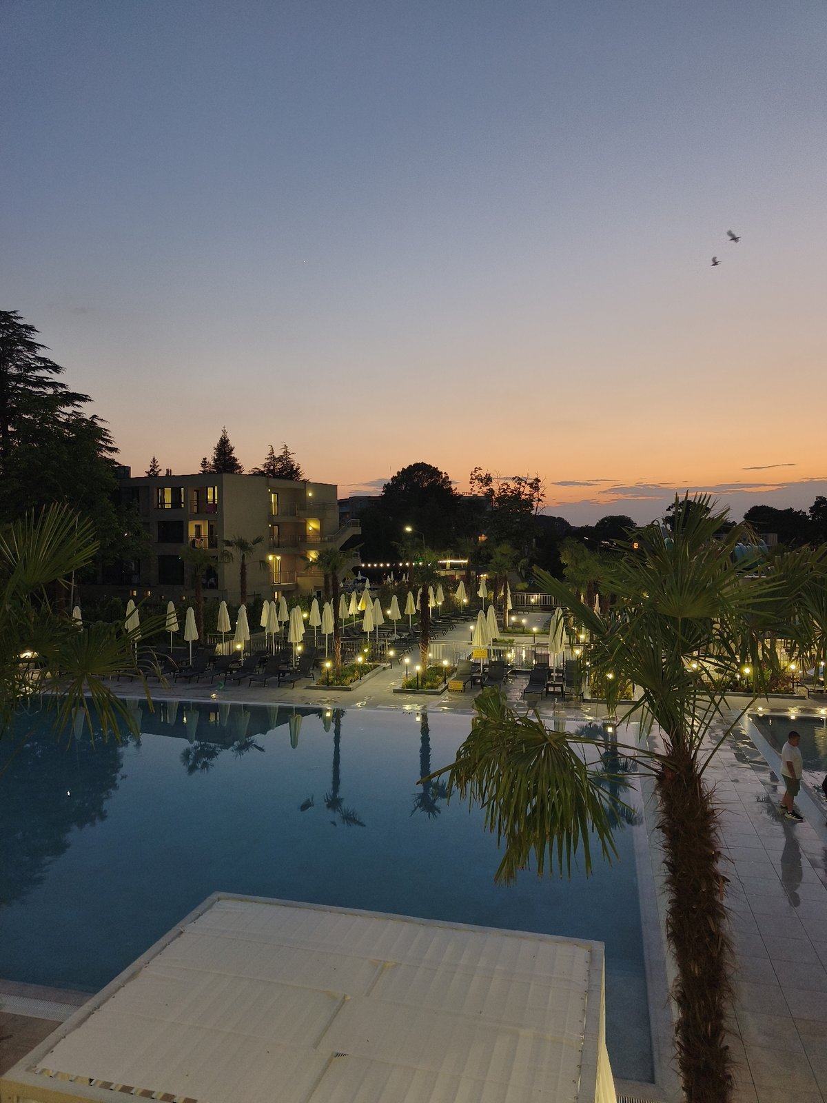 Evening at a beach resort town, pool to night market