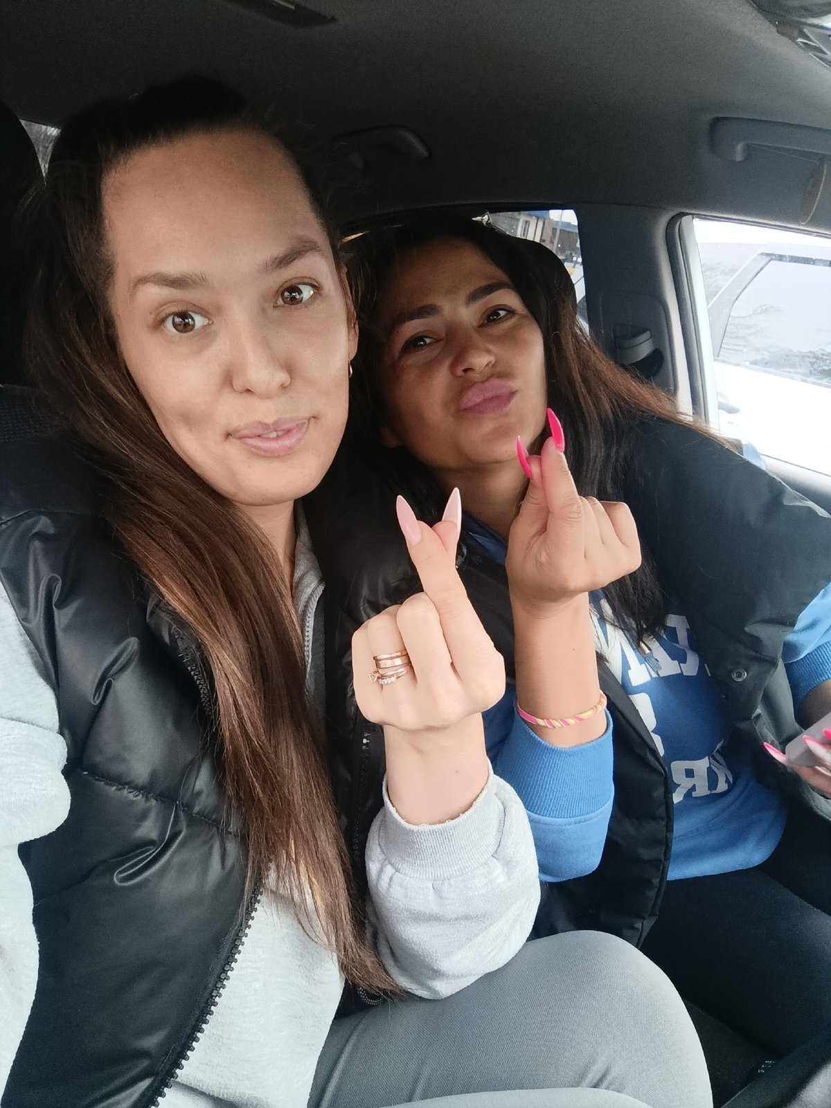 Two women share casual car selfies in Chaikovsky, Russia