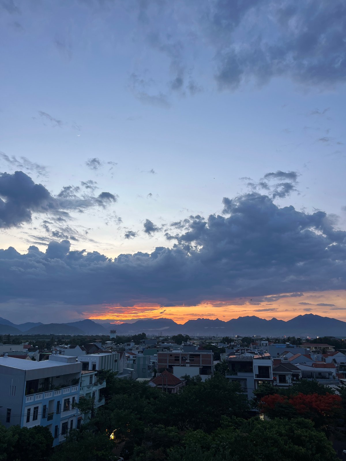 Storm clouds meet golden sky over Đà Nẵng at dusk