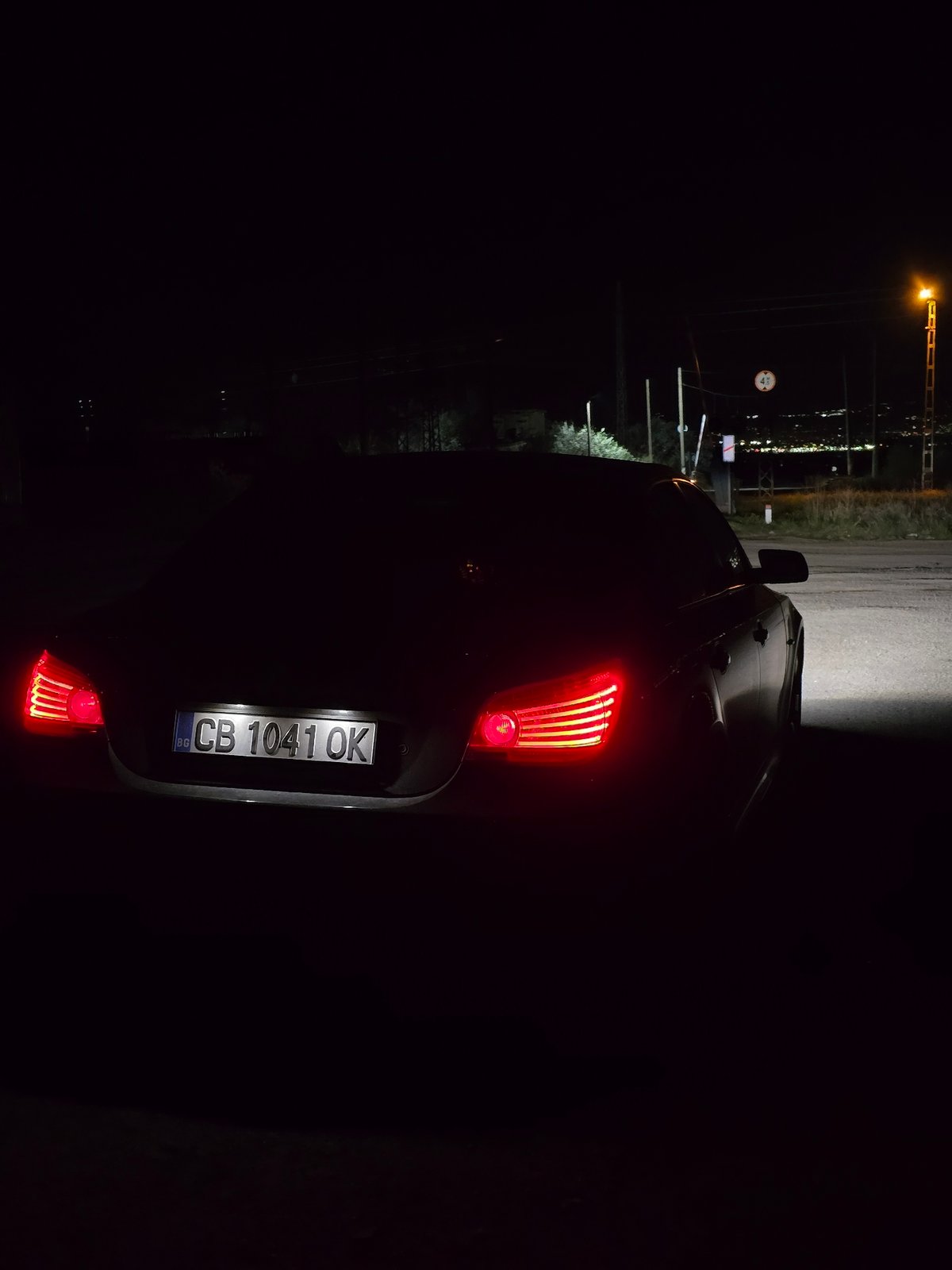 Car with brake lights observed in nighttime Sofia street