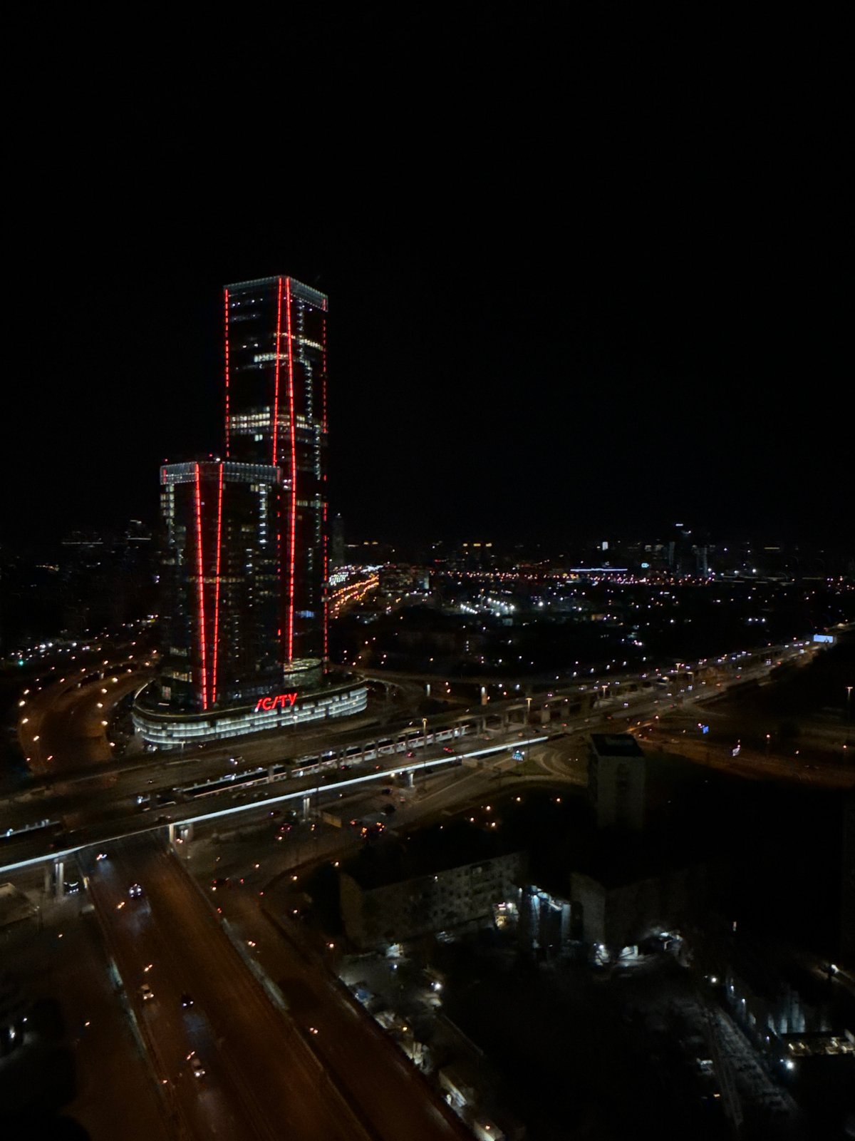 Nighttime aerial view captures illuminated skyscrapers in Khimki, Russia
