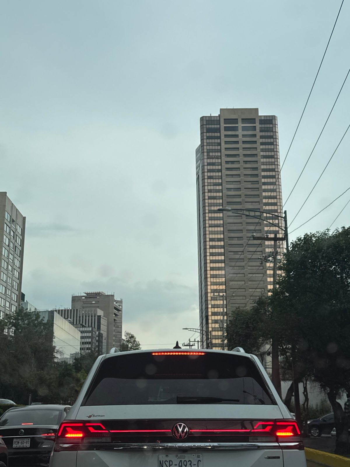 Urban street photographed from elevated view under overcast evening sky