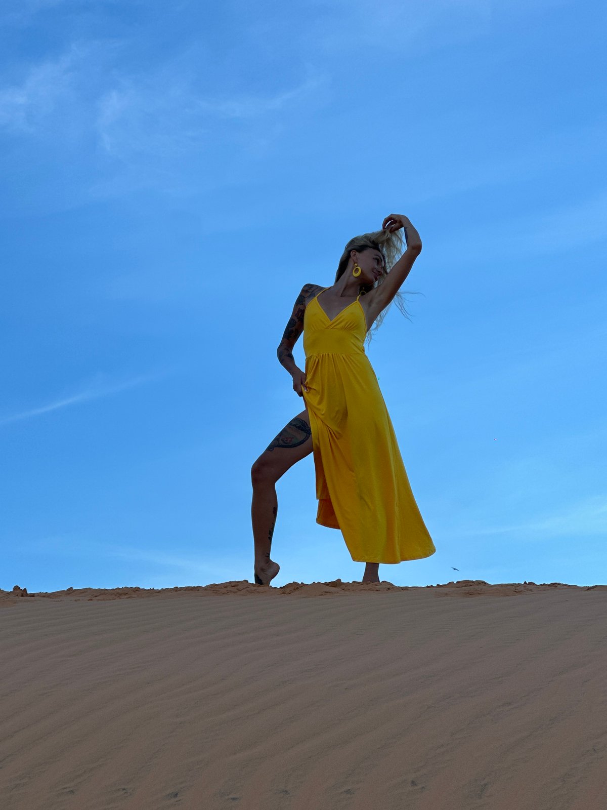 Portrait shoot on the Mui Ne sand dunes, yellow dress, blue sky