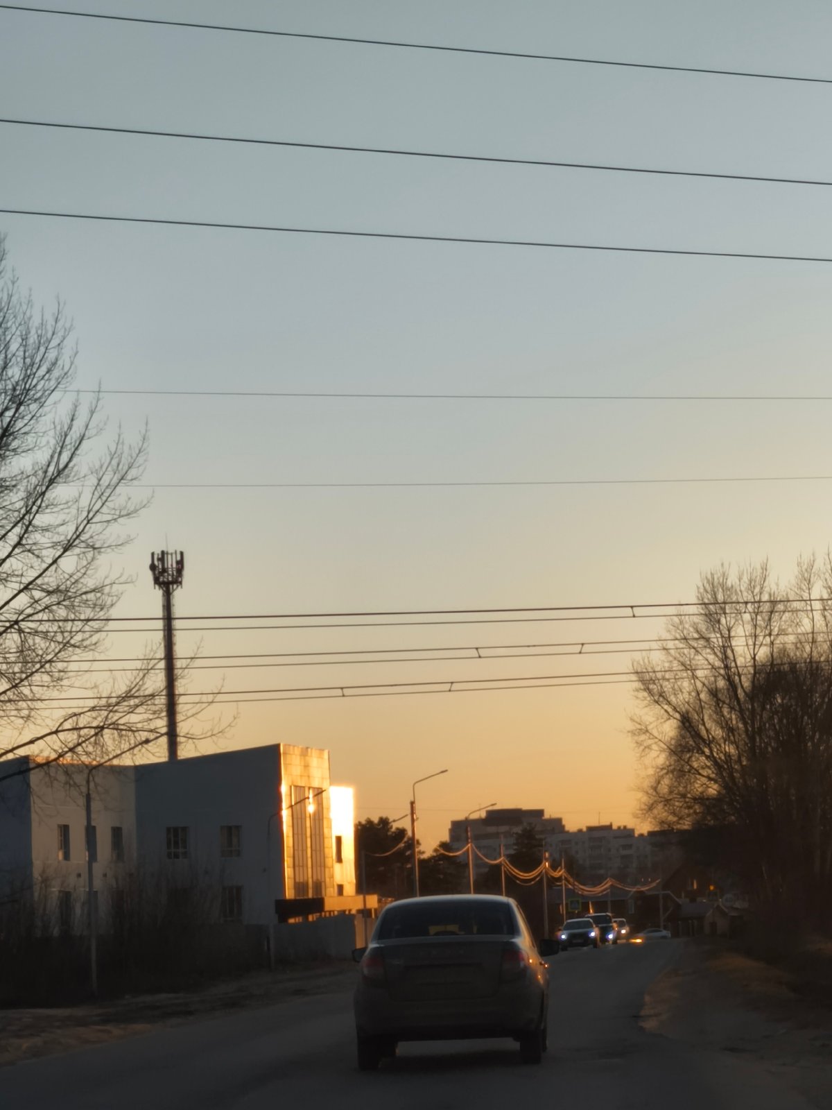 Routine traffic documented on institutional road during golden hour