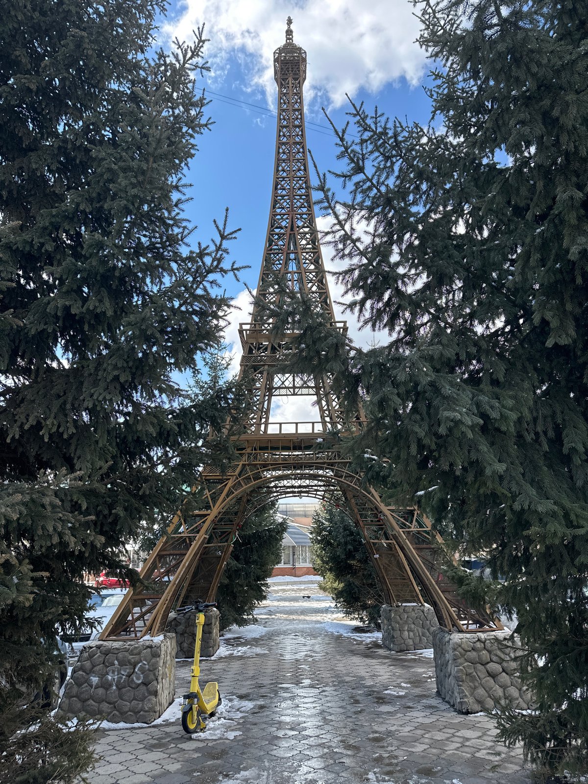 Tourist photographs Eiffel Tower replica in snowy Krasnoyarsk