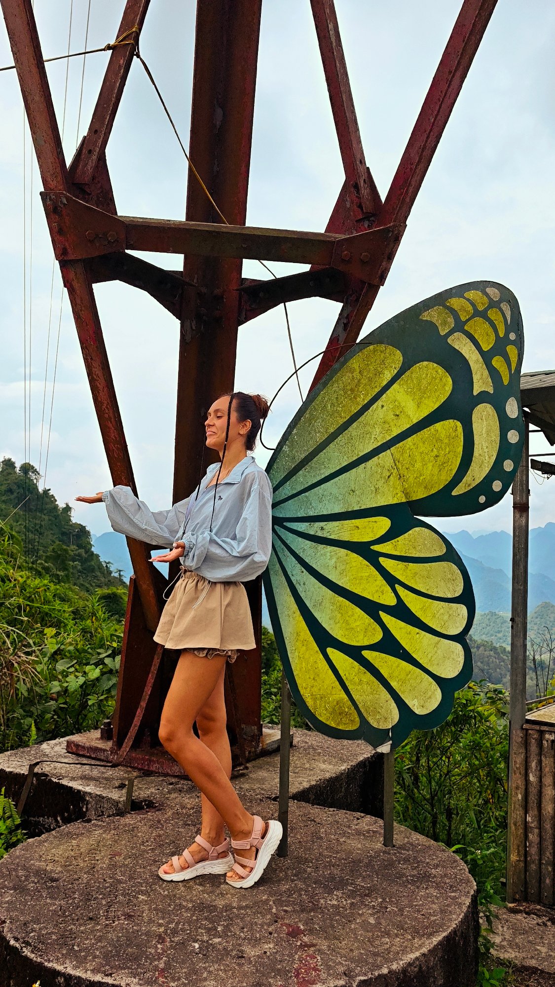 Tourists pose at butterfly displays in northern Vietnam mountains