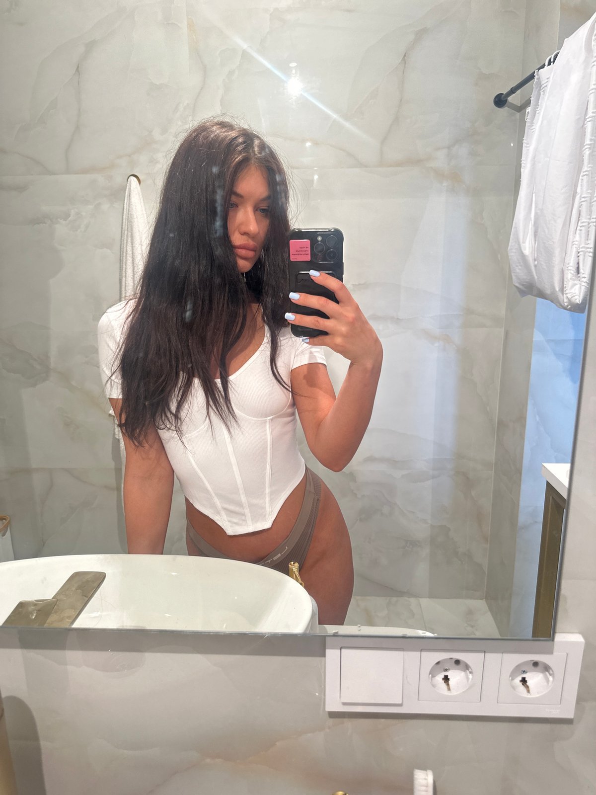 Woman takes bathroom mirror selfies in Moscow