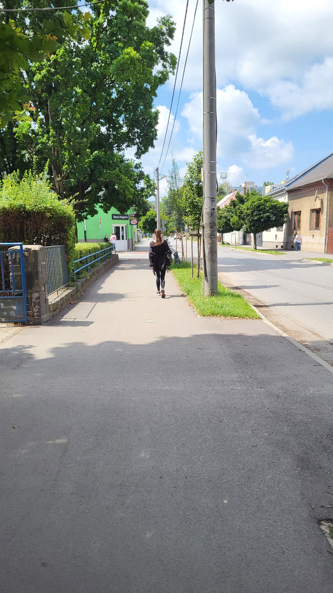 Morning foot traffic and a delivery rider on Prešov sidewalks