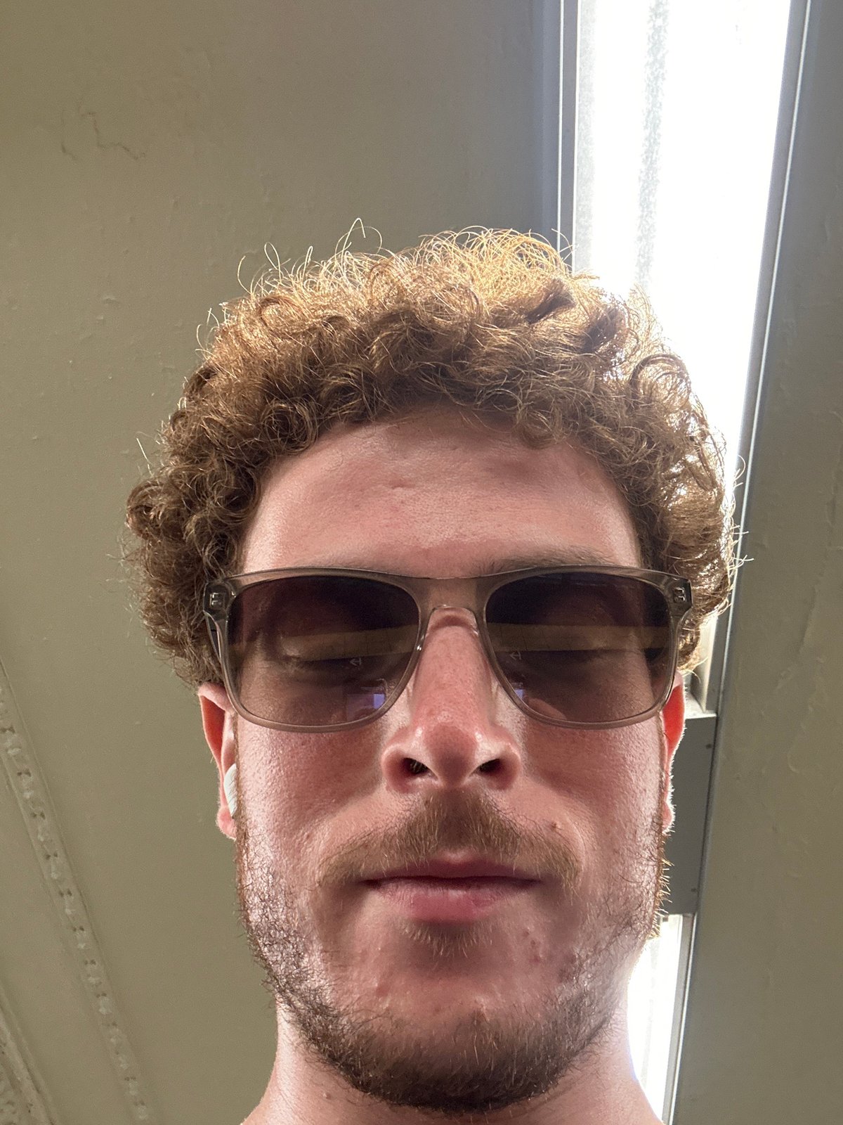 Bearded person photographed under fluorescent lights in New York