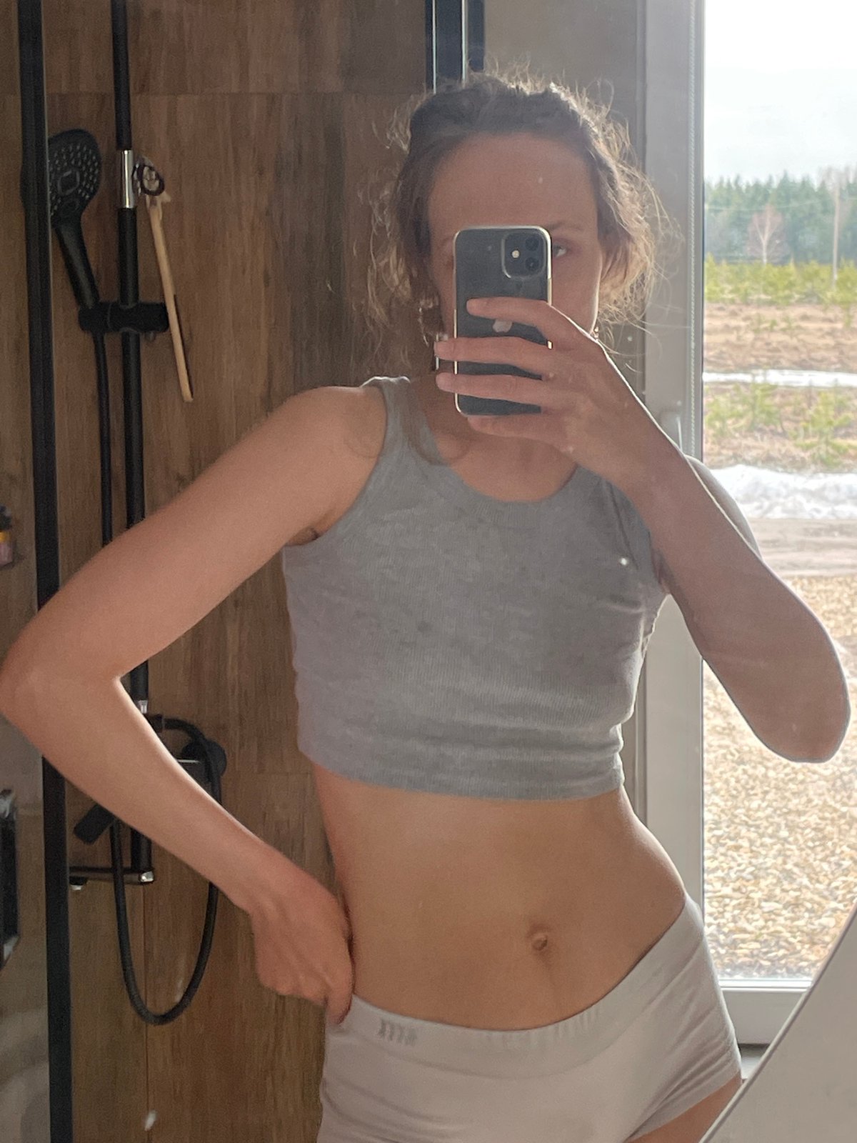 Woman takes bathroom selfies in Podshivalovo, Russia morning