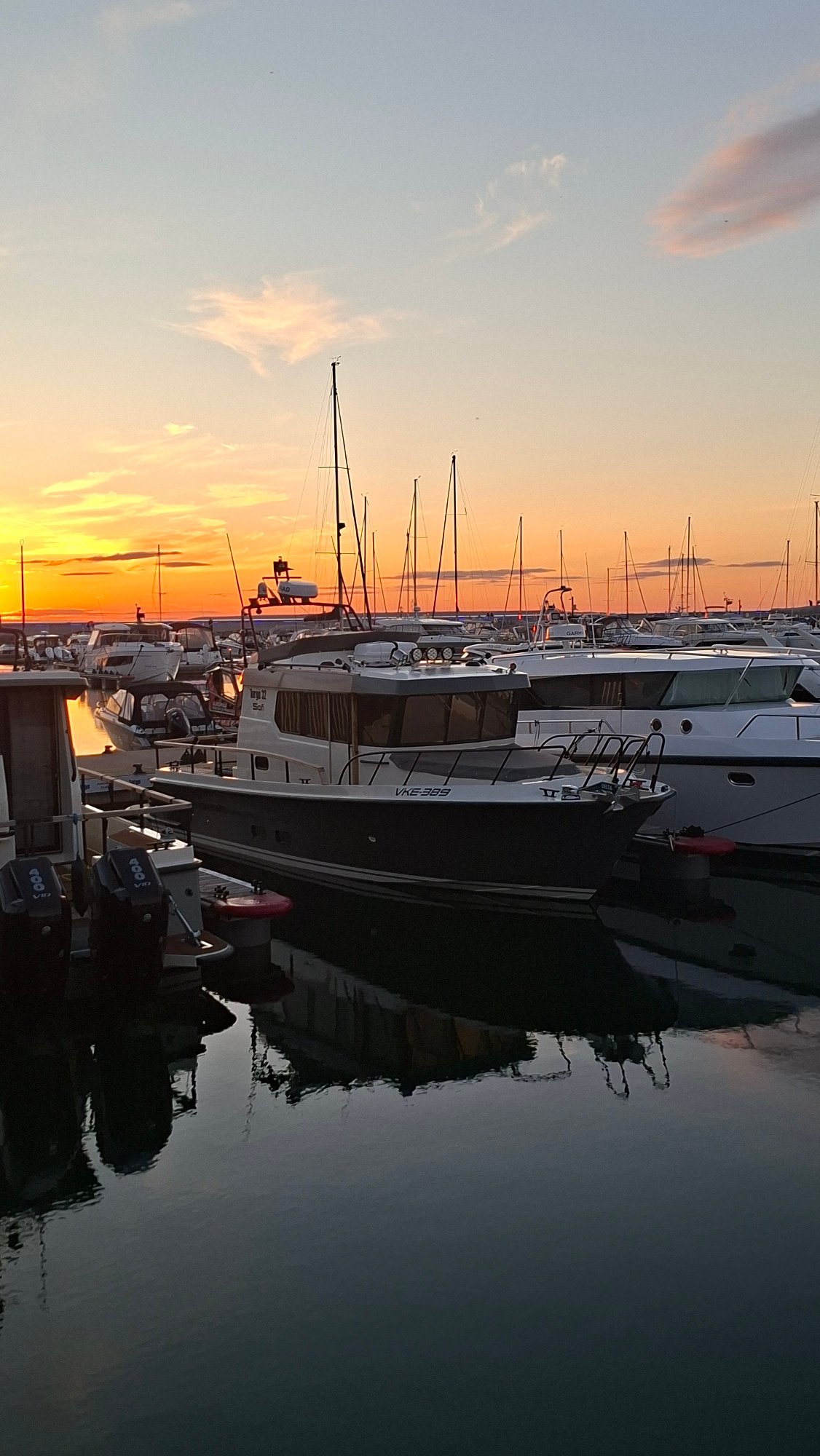 Sunset over Tallinn's marina, boats and golden light.