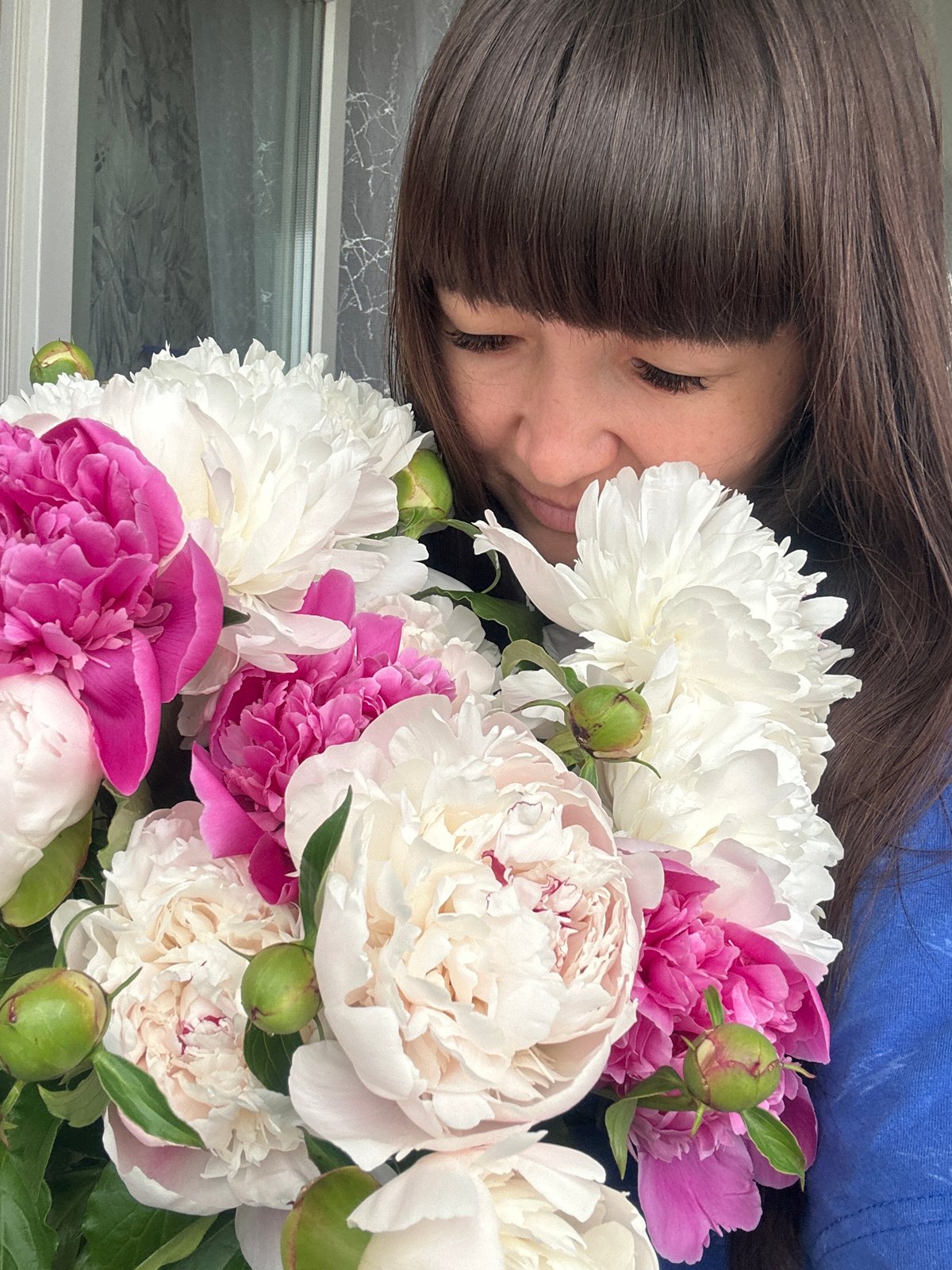 Woman poses with peony bouquet in Chaikovsky, Russia