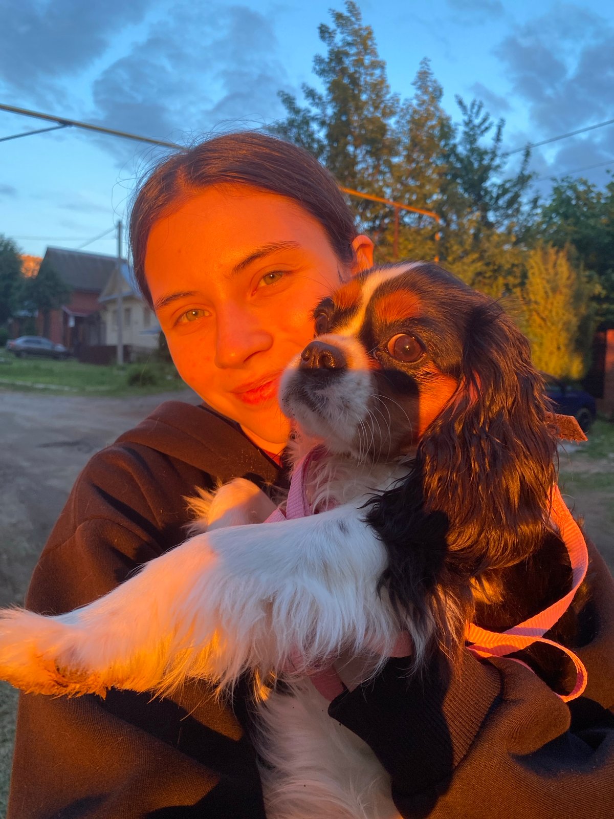 Woman poses with dog during sunset in Votkinsk, Russia
