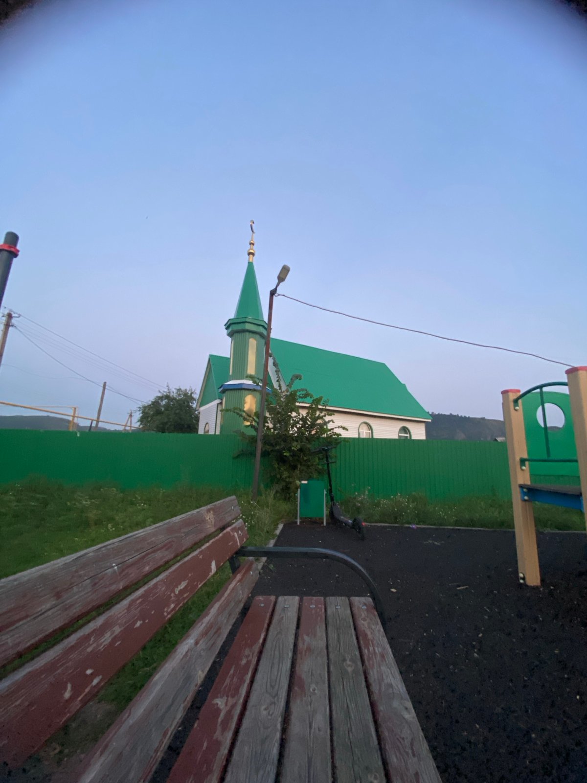 Dusk outing in a small Russian village, mosque and playground in view