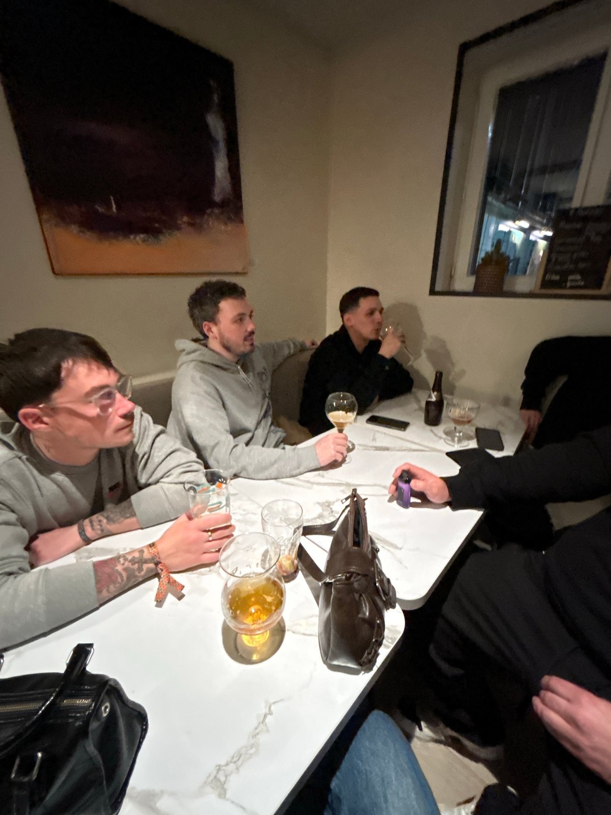 Group shares drinks at table in Hem, France