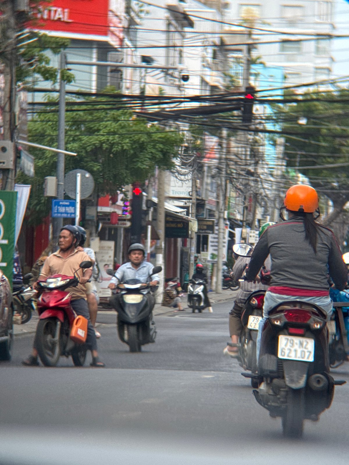 Morning motorbike traffic moves through a Nha Trang intersection