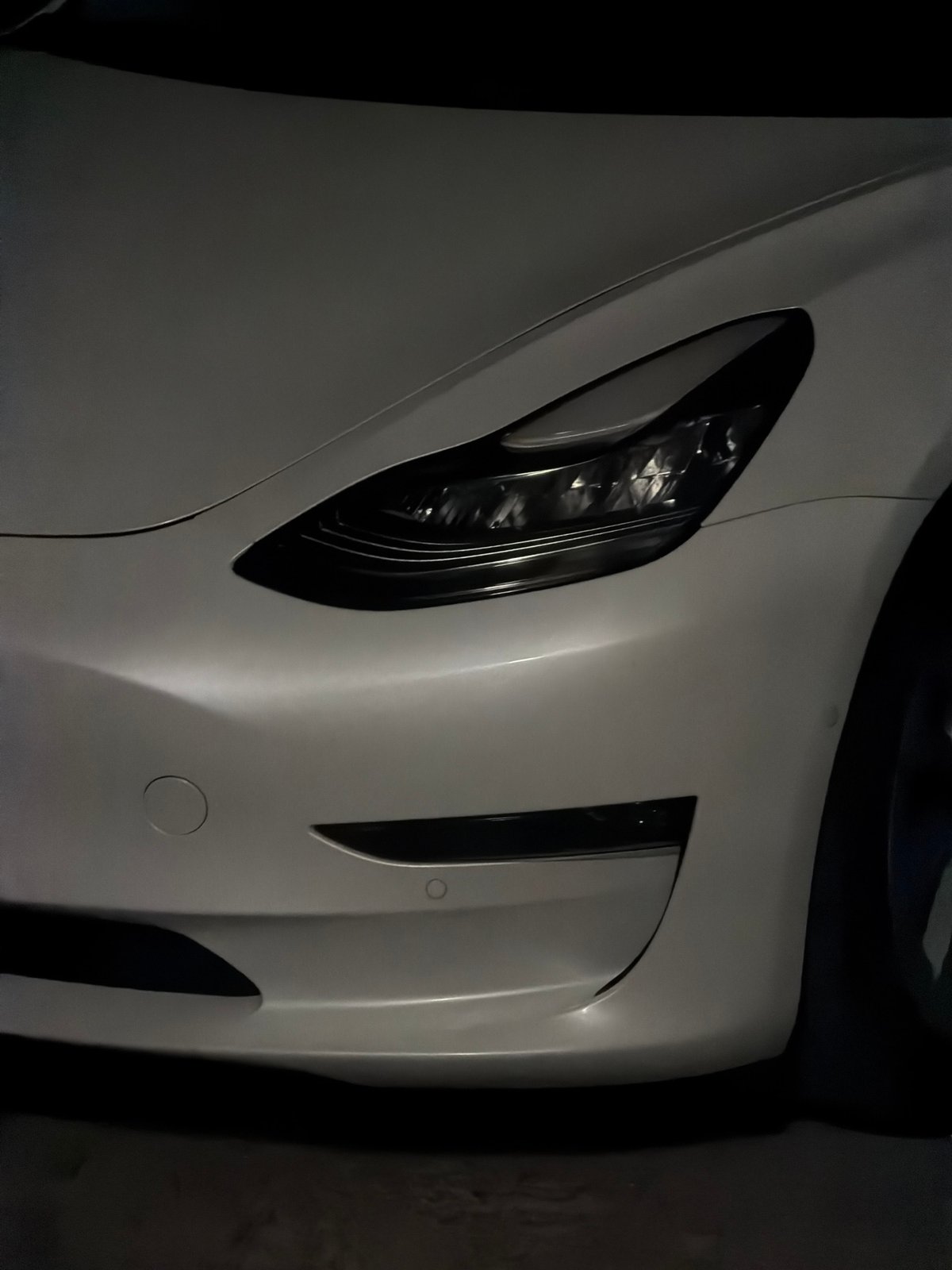 Late-night hangout at a Bila Tserkva property with a Tesla outside