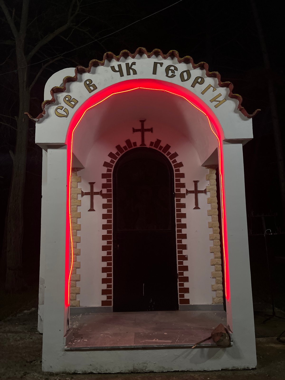 Religious monument glows with red lighting in Sungurlare, Bulgaria