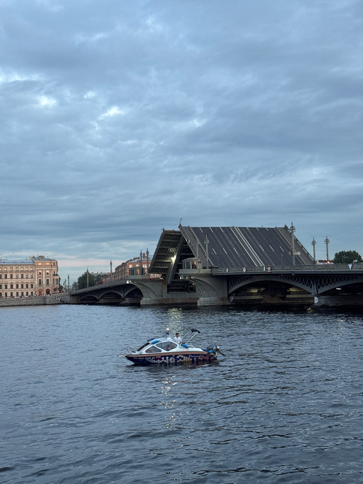 Evening on the Neva: drawbridges, a barge sculpture, Saint Petersburg skyline