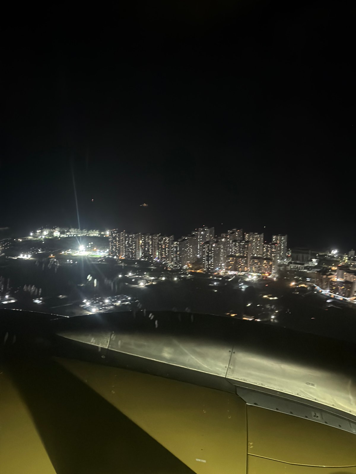 Nighttime aerial view of illuminated Malé captured from aircraft